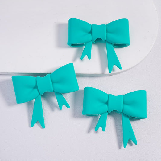 Three turquoise bows on a white background