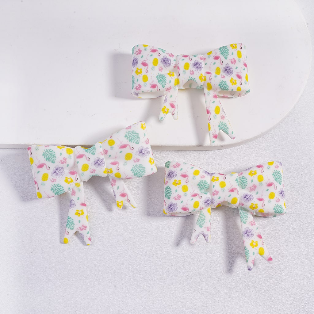 Set of three floral-patterned bows on a white background