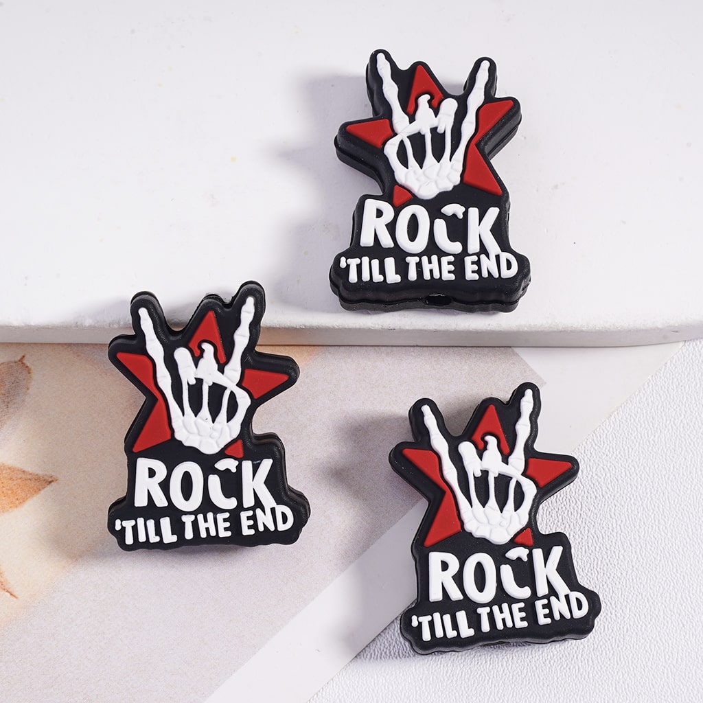 Three 'Rock Till the End' hand gesture pins on a white background