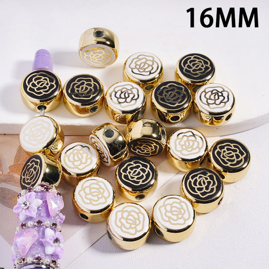 Gold, black, and white beaded jewelry with a purple bead on a white background