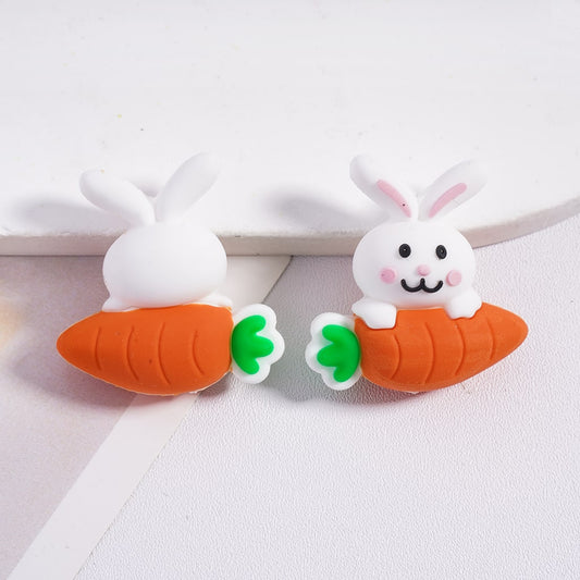 Two cartoon-style bunny carrot clips on a white background