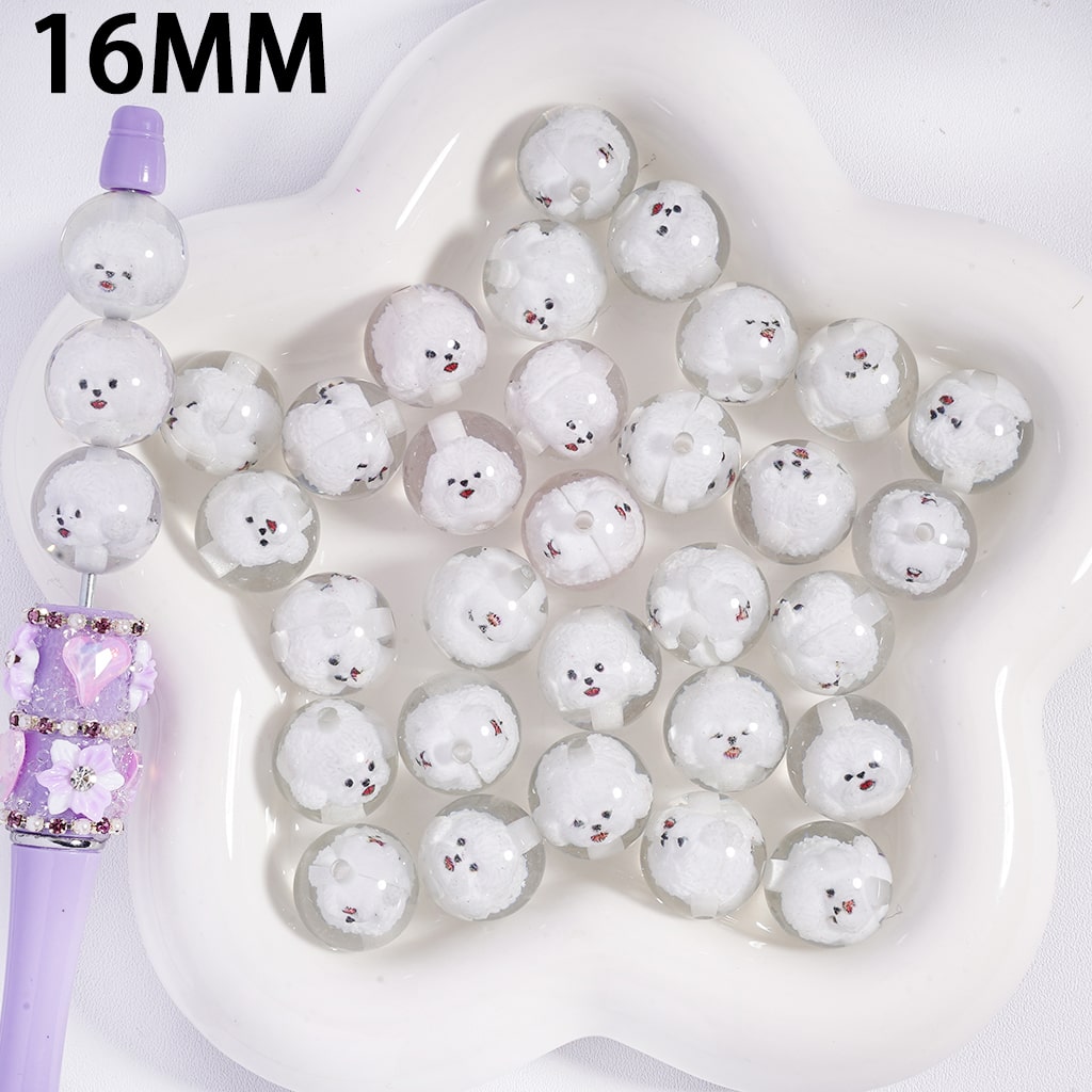 White round beads with cute faces on a white dish, with a purple handle.