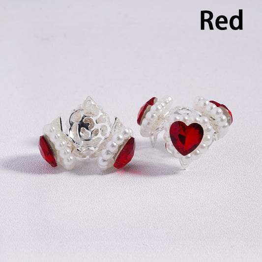 Two silver beads with red heart and rose designs on a white background.