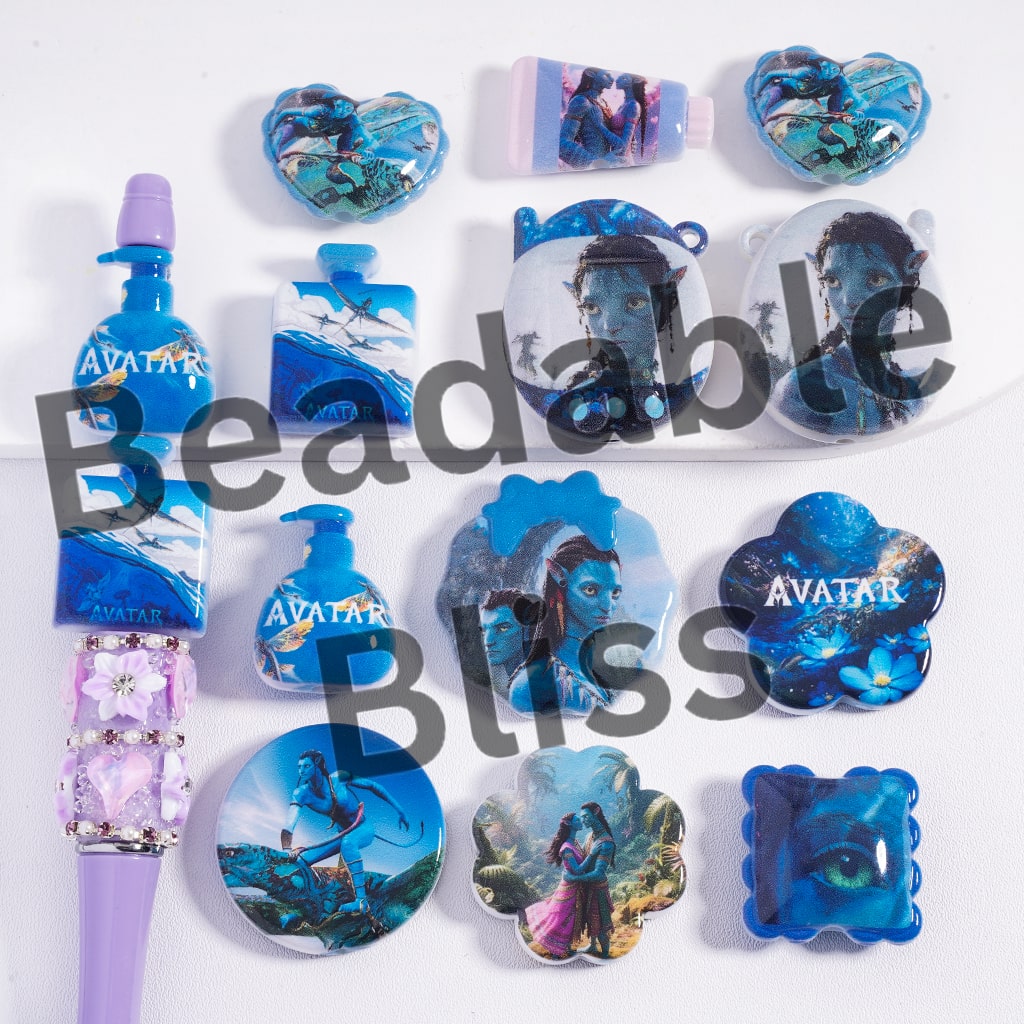 Collection of 'Avatar' themed items including magnets and a pen on a white background.