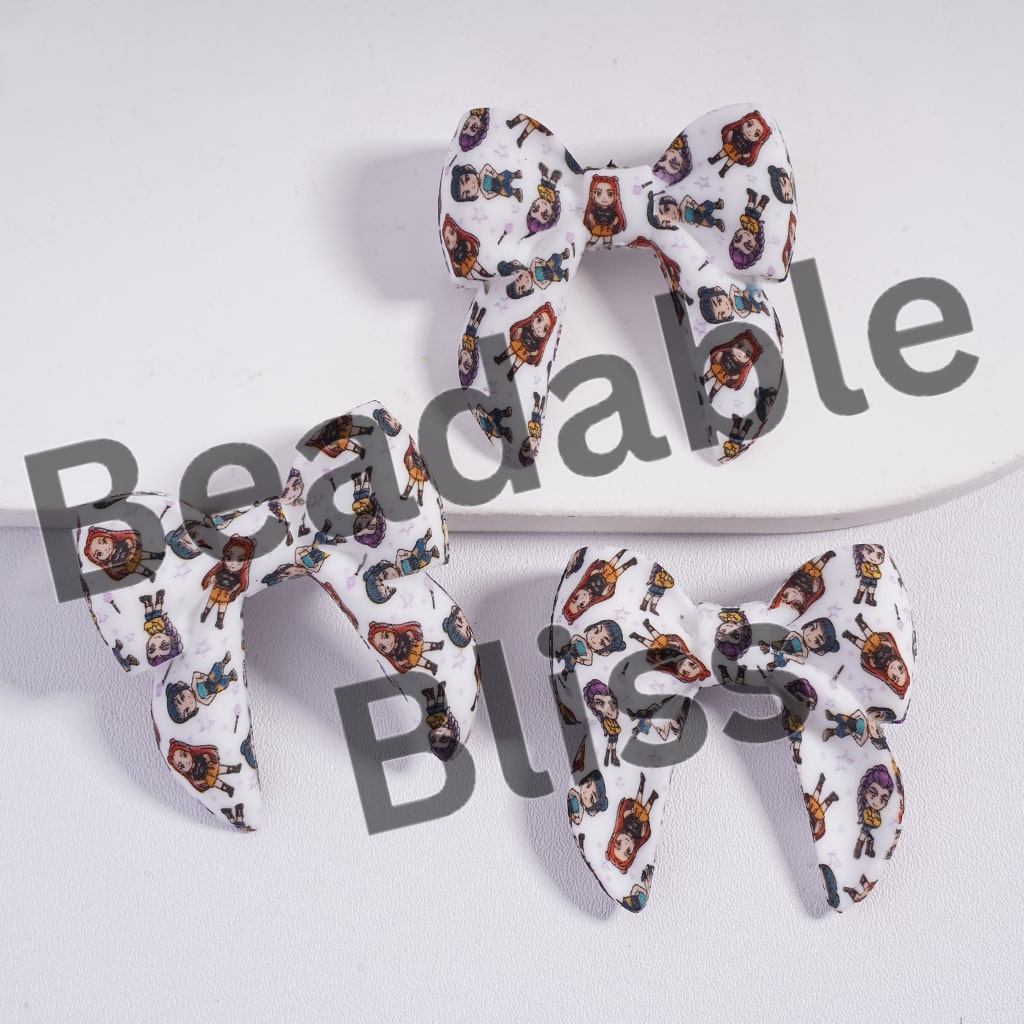 Three fabric bows with character pattern on a white background, branded 'beadablebliss'.