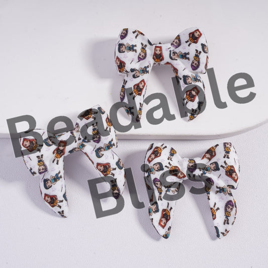 Three fabric bows with character pattern on a white background, branded 'beadablebliss'.