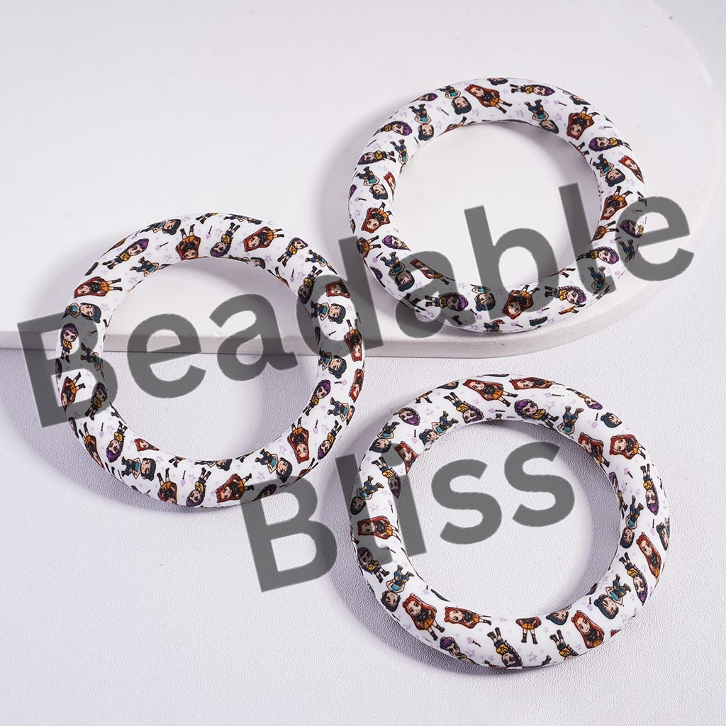 Three circular objects with a pattern of small images on a white background, branded 'beadablebliss'.