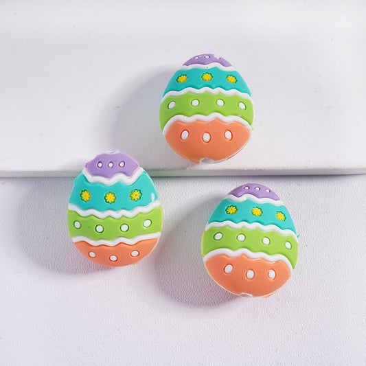Colorful Easter egg-shaped cookies on a white background