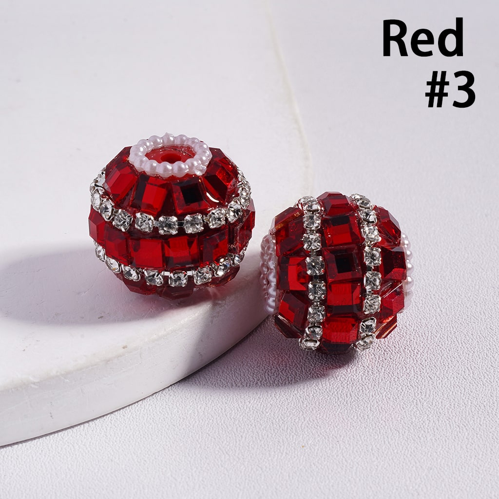 Red beaded jewelry piece with rhinestones on a white background