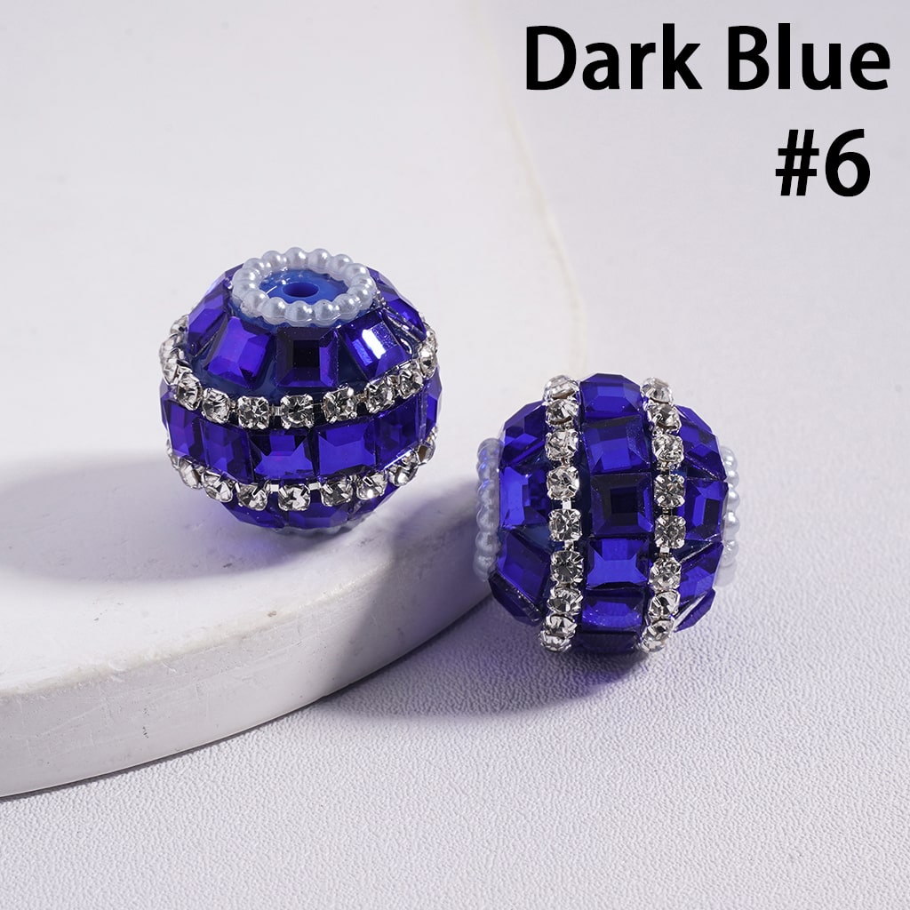 Dark blue beaded earrings with silver accents on a light gray background