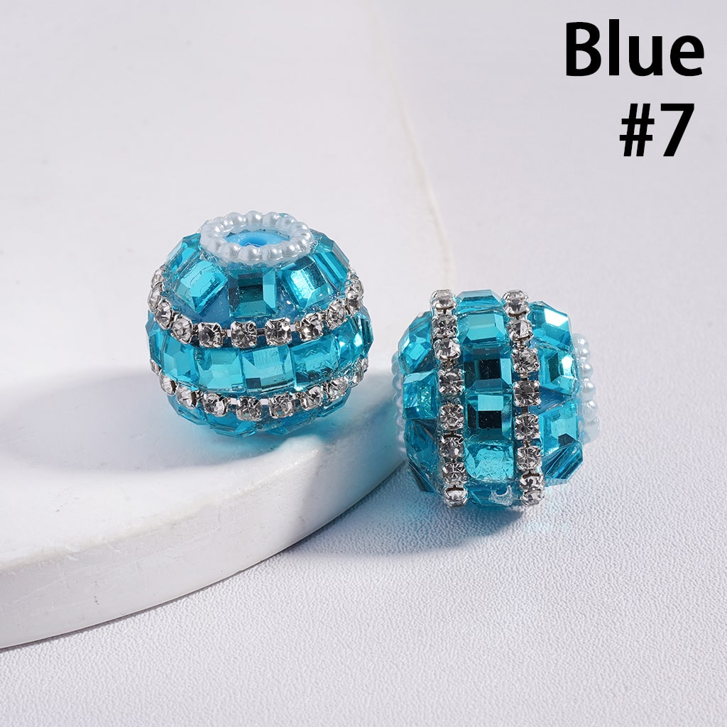 Blue crystal beads with silver accents on a white surface, labeled 'Blue #7'.