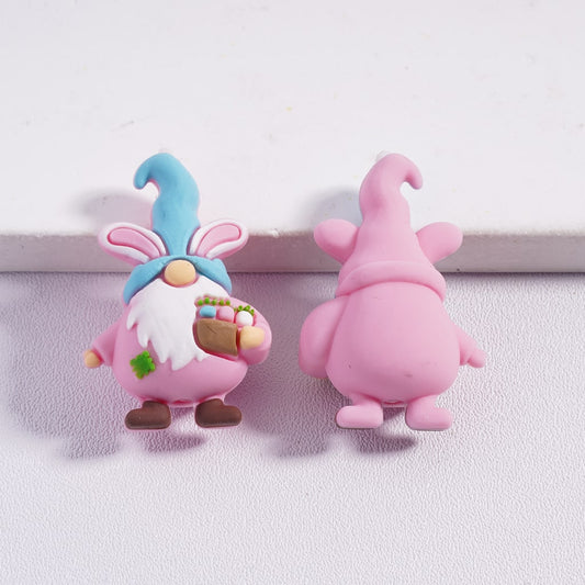 Two pink cartoon-like figures with blue and pink hats on a white background