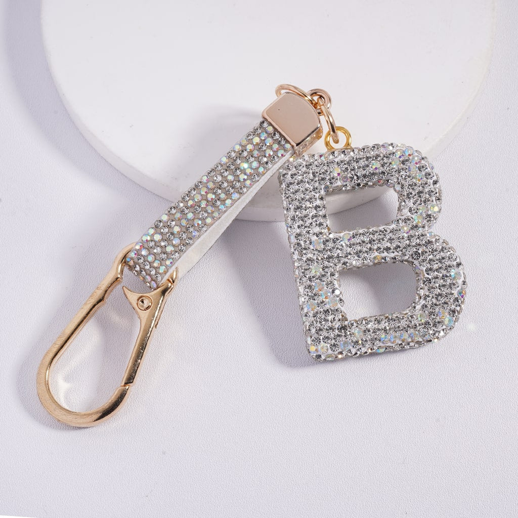 Keychain with letter 'B' made of sparkling material on a light background