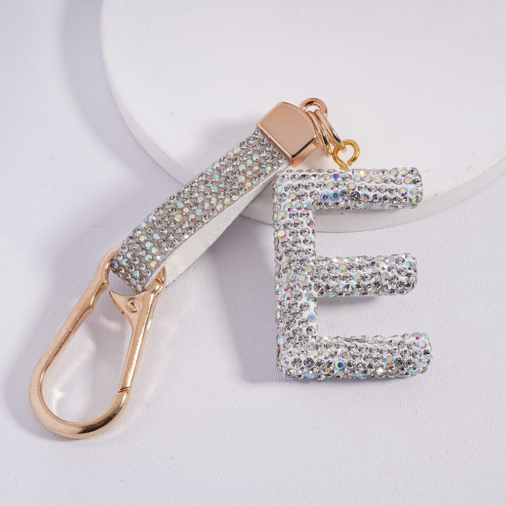 Keychain with letter 'E' made of rhinestones on a light gray background