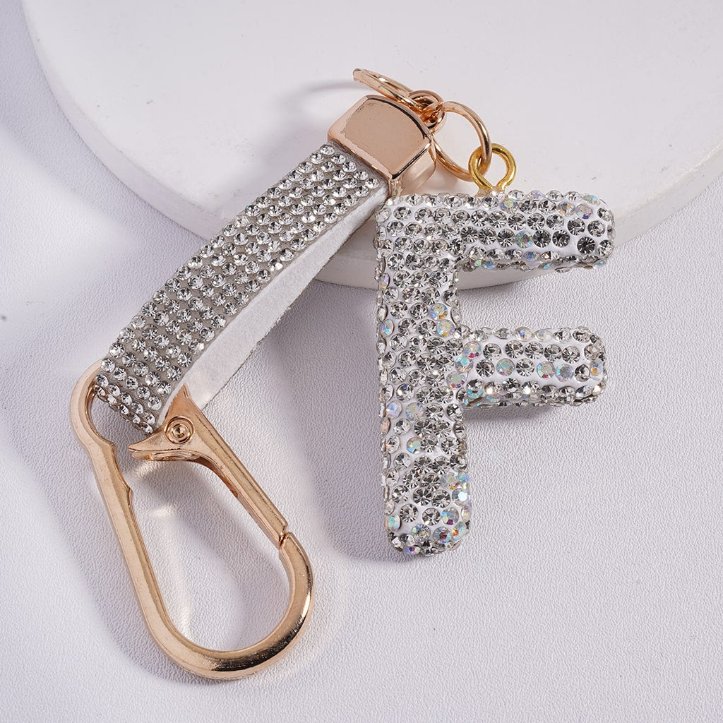 Keychain with letter 'F' and gold carabiner on a light background