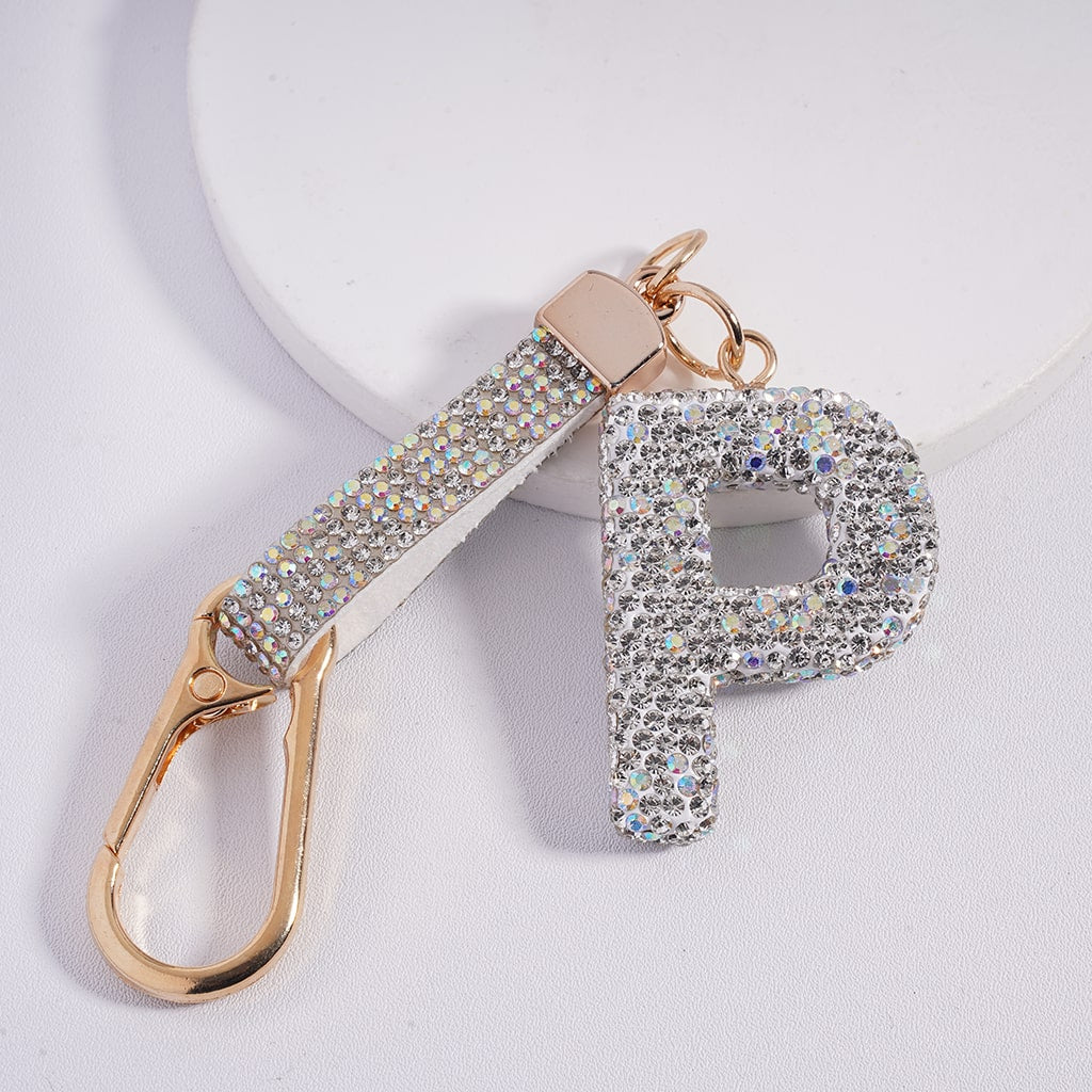 Keychain with letter 'P' and gold carabiner on a light gray background