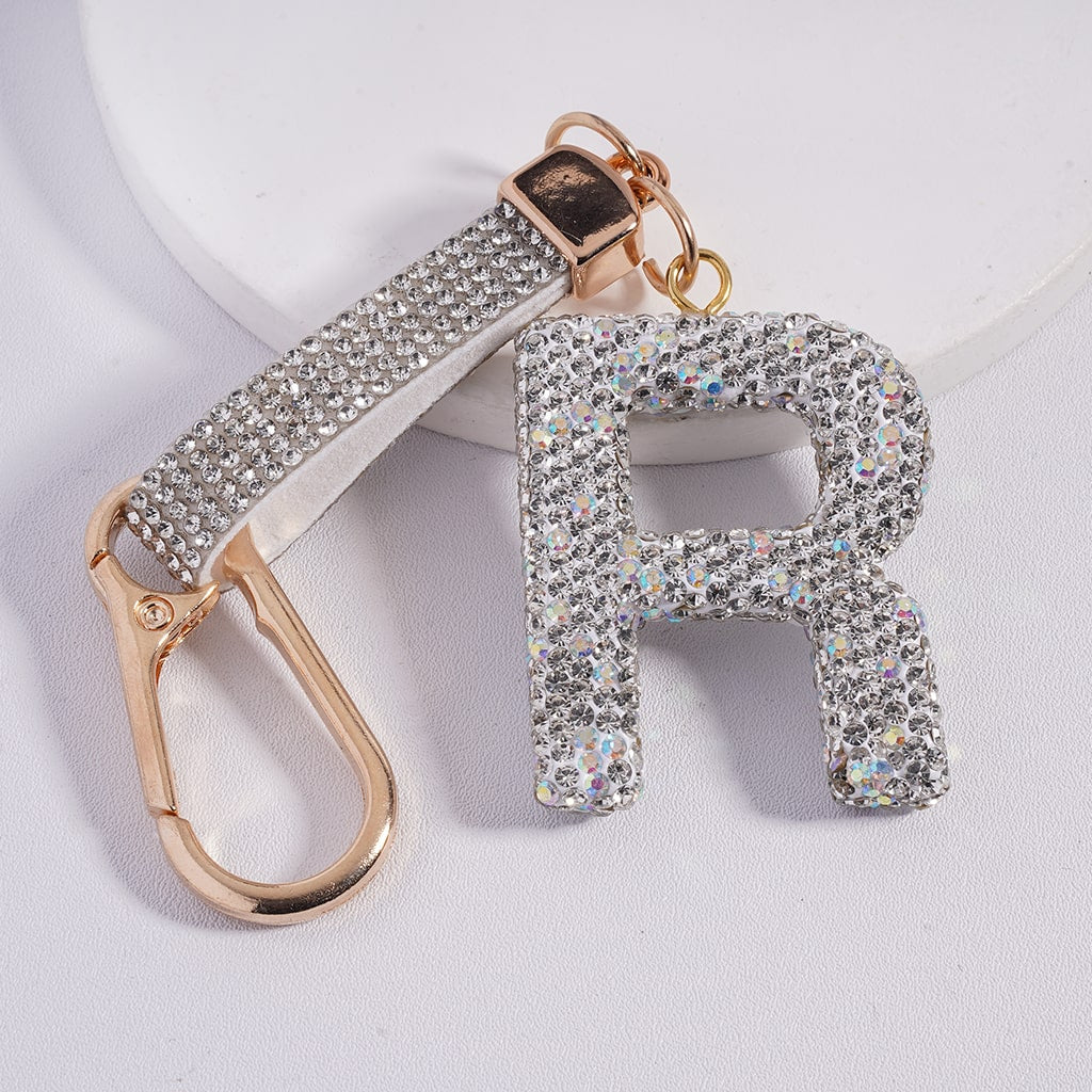 Keychain with 'R' letter and carabiner on a light background