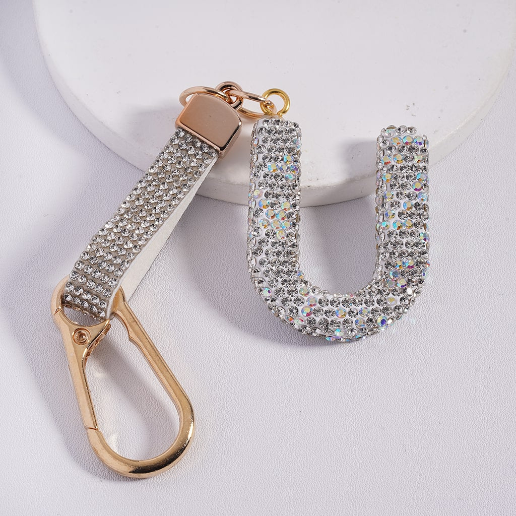 Keychain with rhinestone 'U' design on a white background