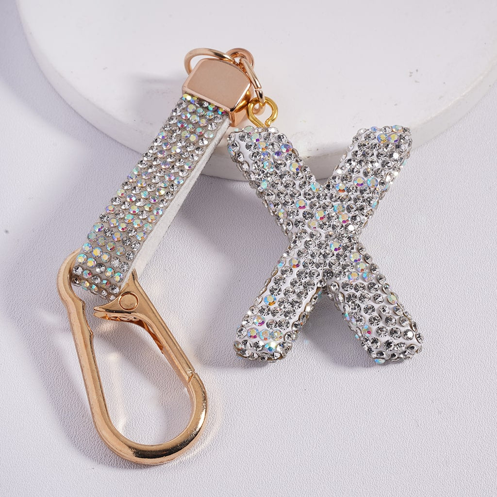 Keychain with 'X' letter and gold carabiner on a white background