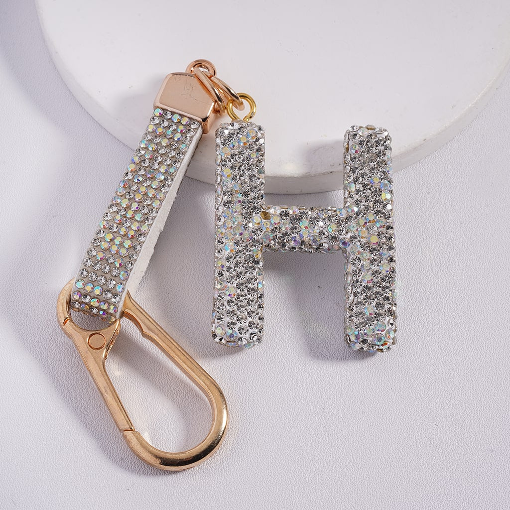Keychain with 'H' letter and gold carabiner on a white background