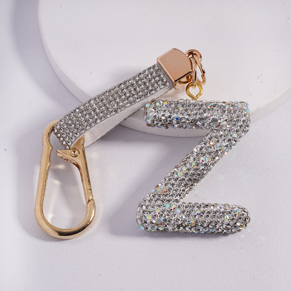 Decorative keychain with letter 'Z' and gold carabiner on a light background
