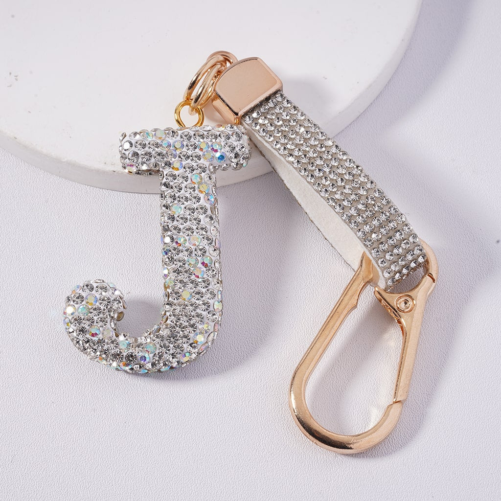 Keychain with letter 'J' and rose gold carabiner on a white background