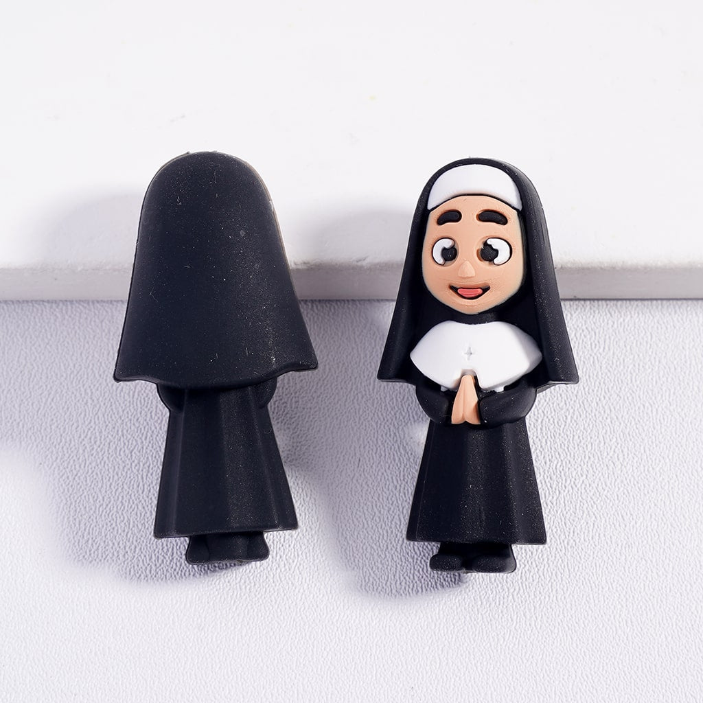 Two nun-themed magnets on a white surface