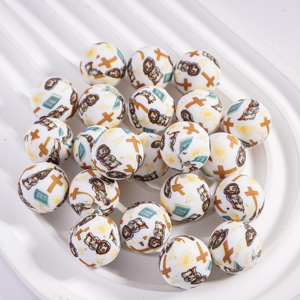 Decorative beads with animal patterns on a white dish