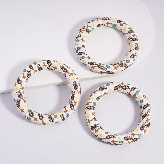 Three circular dog toys with patterned designs on a white background