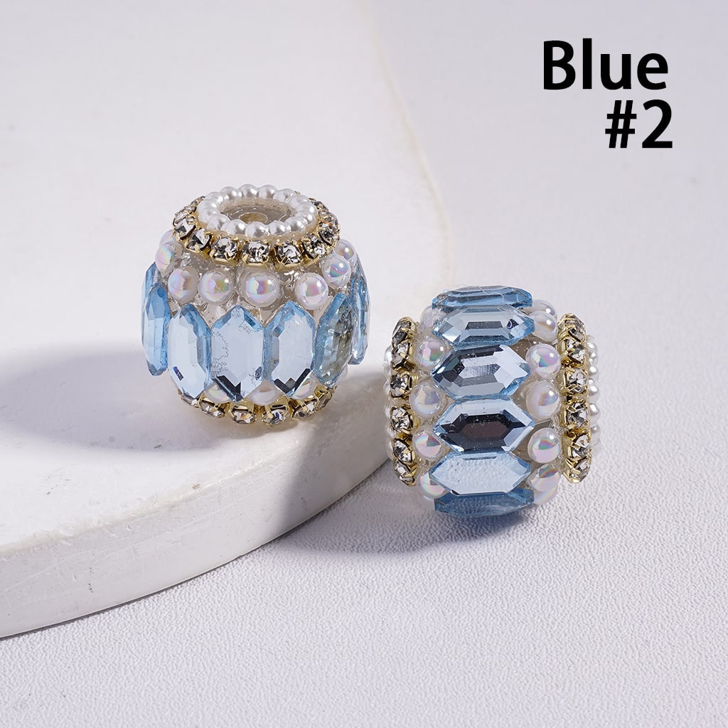 Two blue crystal beads with pearl accents on a white surface, labeled 'Blue #2'.