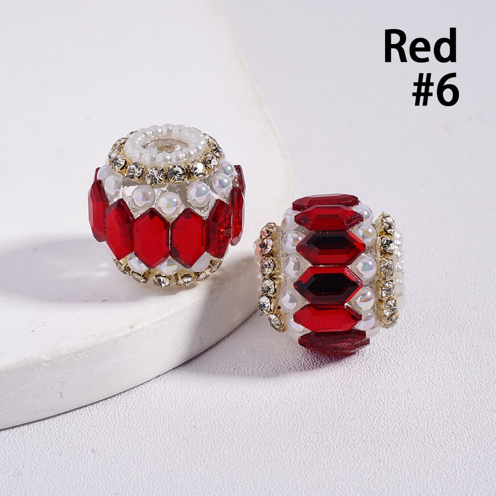Two red and gold beads on a white surface with 'Red #6' text.