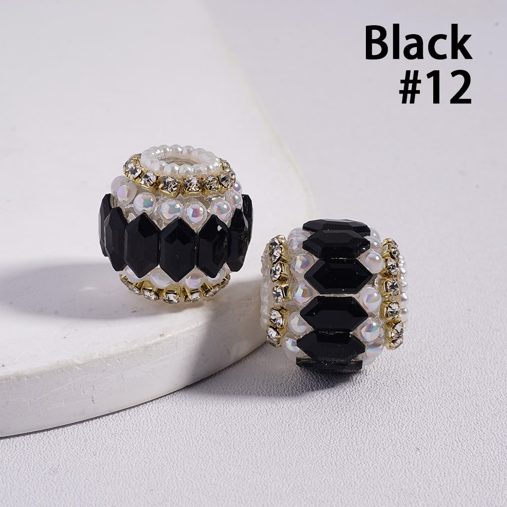 Two black and gold beaded charms on a white surface with 'Black #12' text.