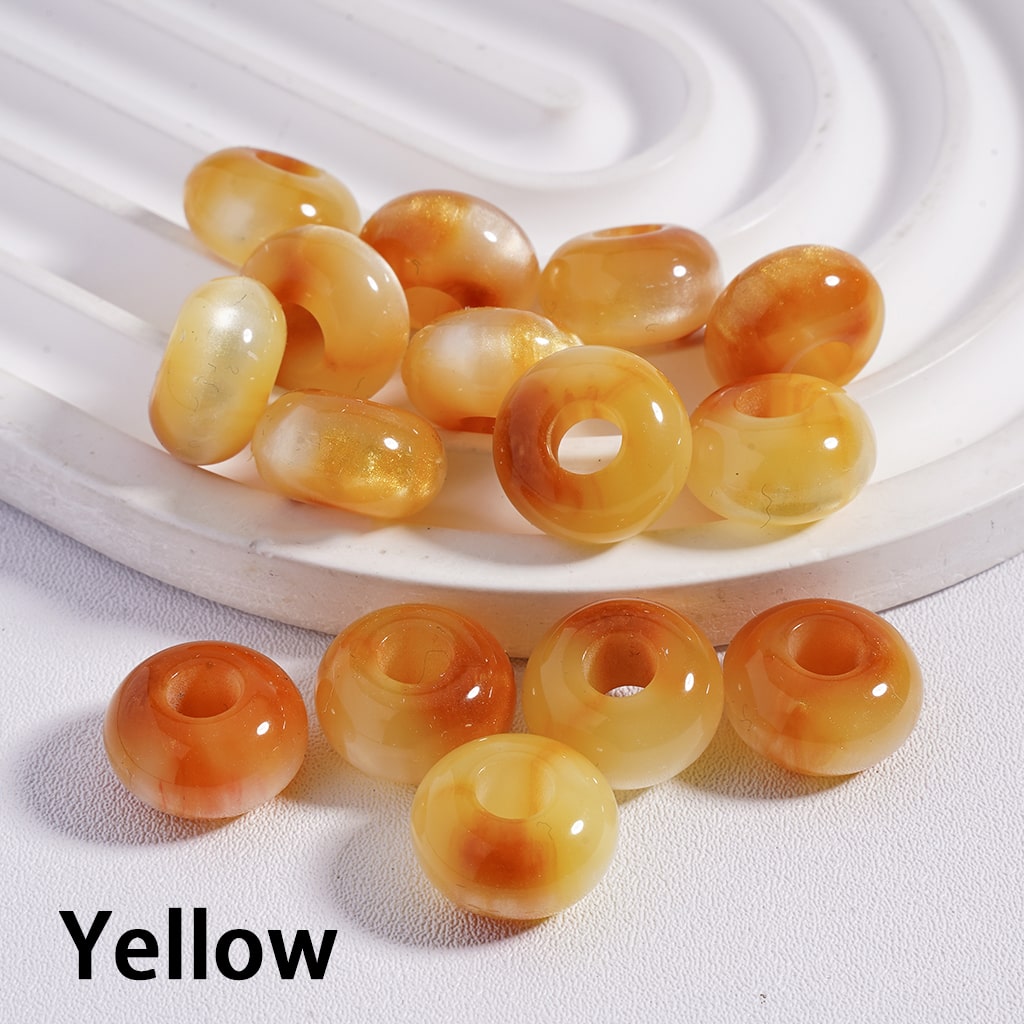 Yellow beads on a white textured surface