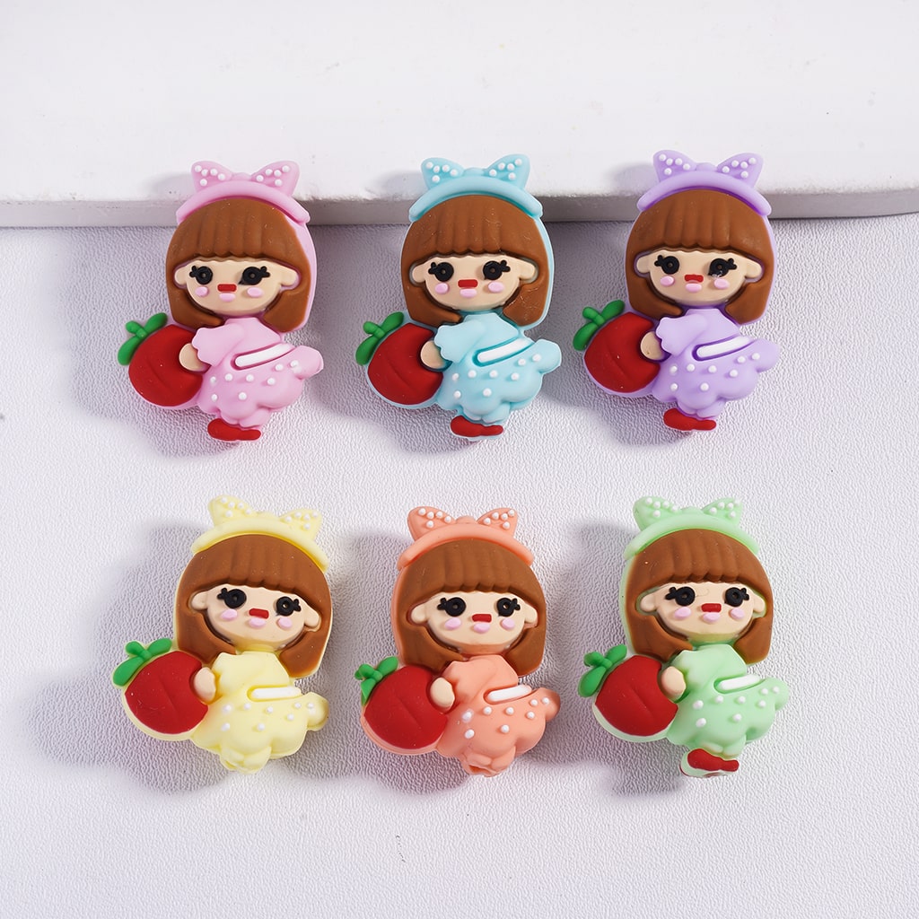 Set of six colorful character figurines with dresses and apples on a white background