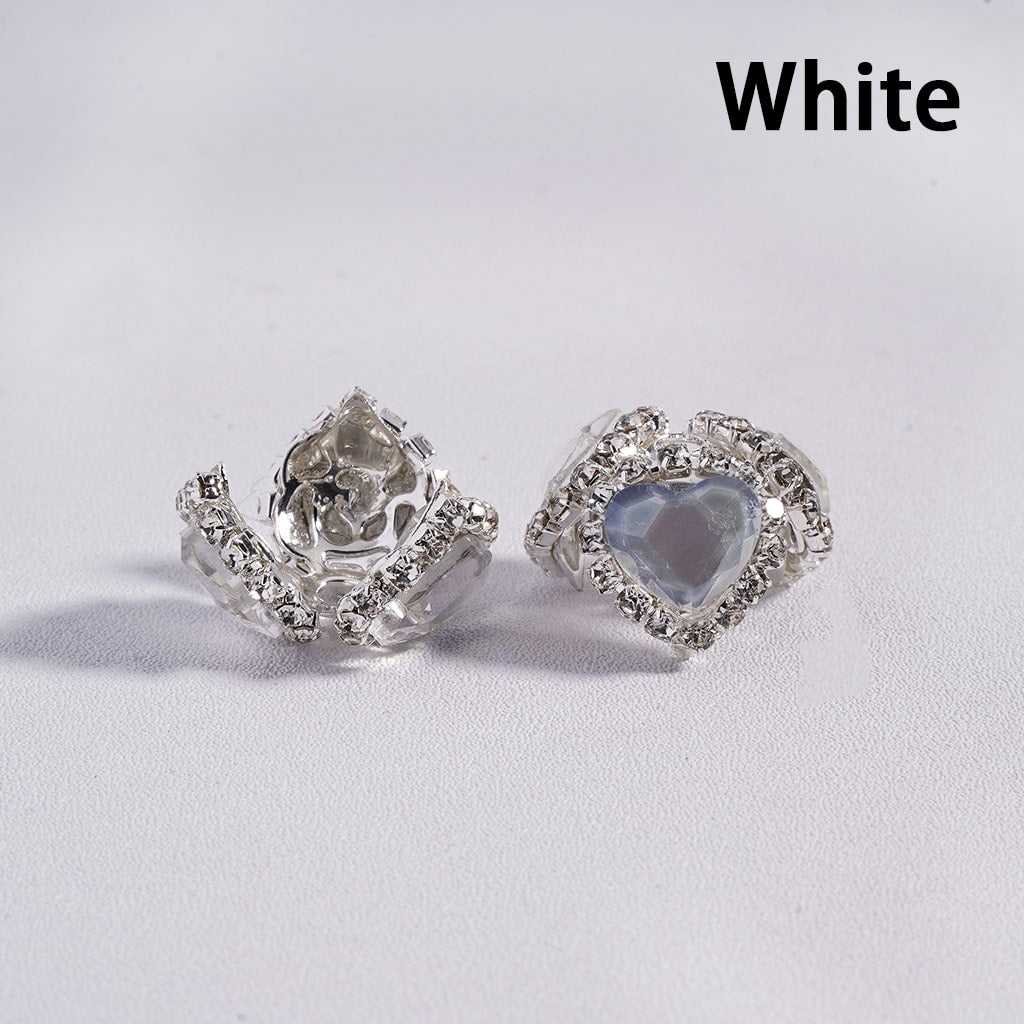 Silver heart-shaped earrings on a white background with 'White' text.
