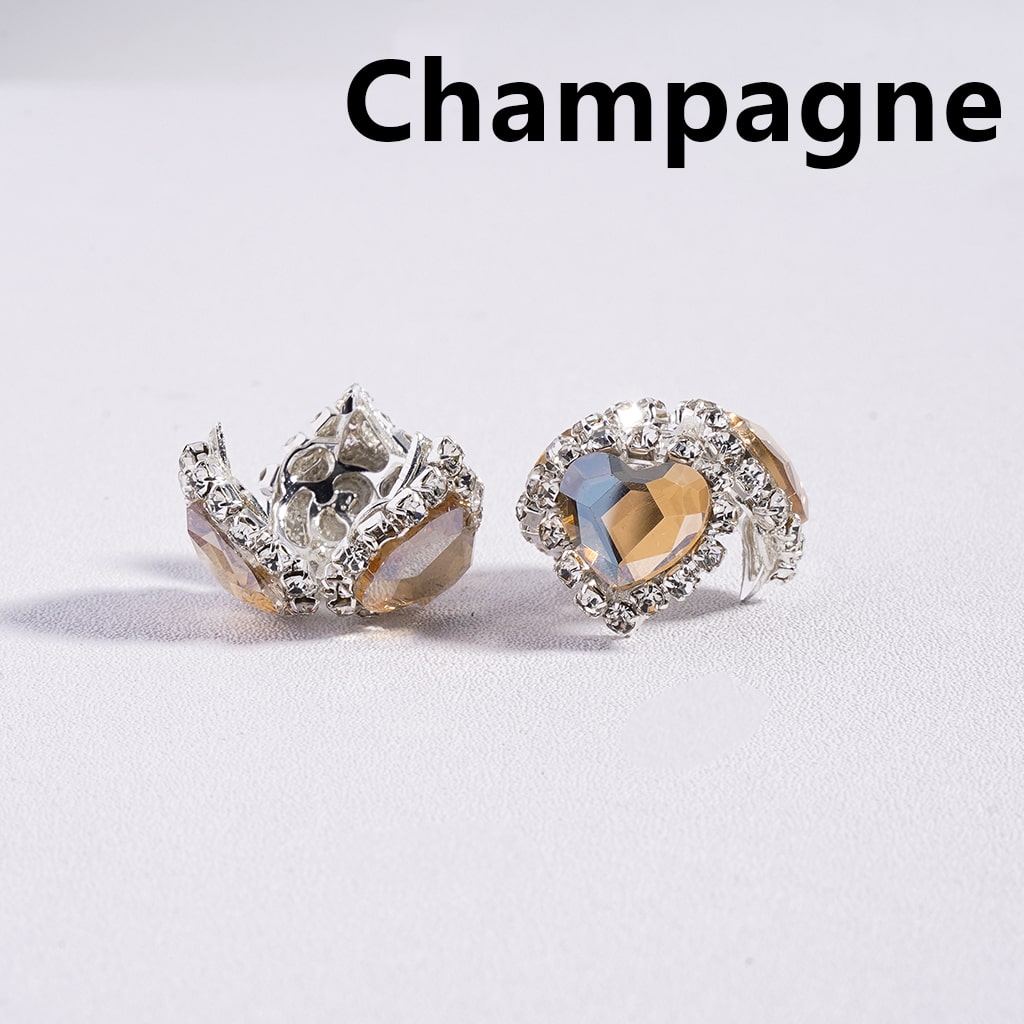 Two sparkling earrings on a light gray background with 'Champagne' text above.
