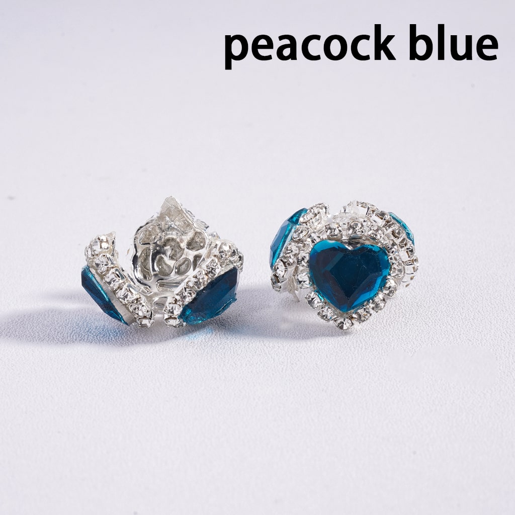 Pair of earrings with blue heart-shaped stones on a white background