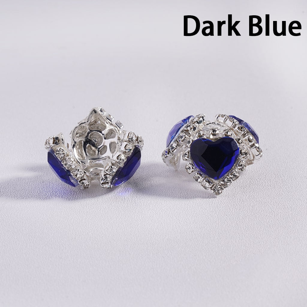 Dark blue heart-shaped earrings with silver accents on a light gray background