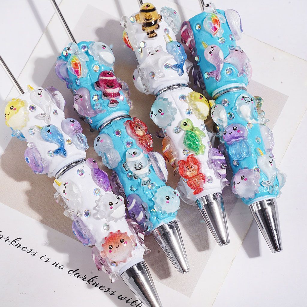 Beadable Clay Pens Fish Sea Turtles Jellyfish Shrimp Dinosaurs and AB Rhinestones, White and Turquoise Background