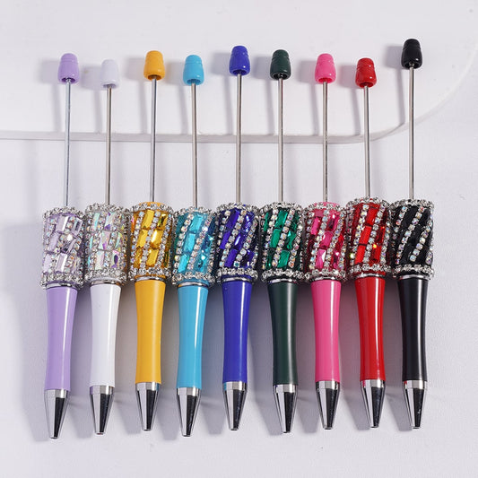 Set of colorful pens with rhinestone accents on a white background
