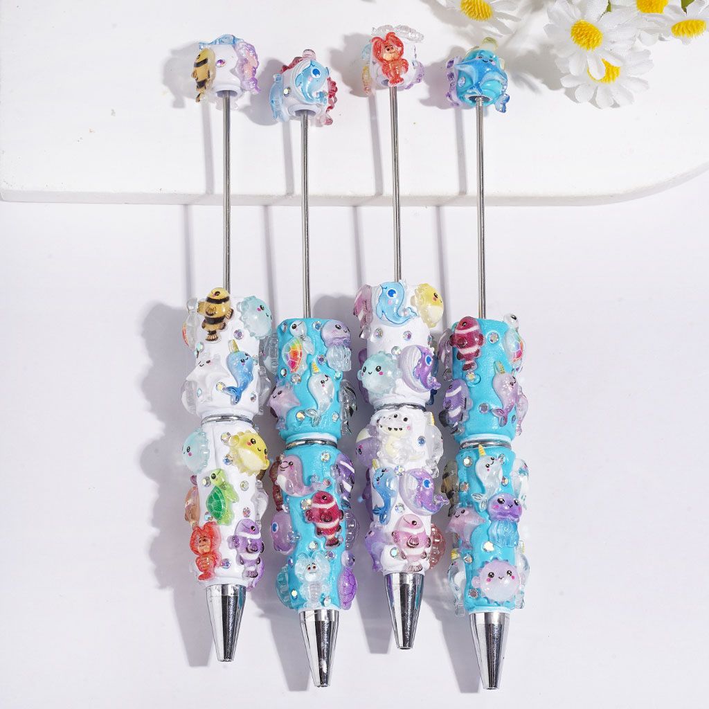 Beadable Clay Pens Fish Sea Turtles Jellyfish Shrimp Dinosaurs and AB Rhinestones, White and Turquoise Background