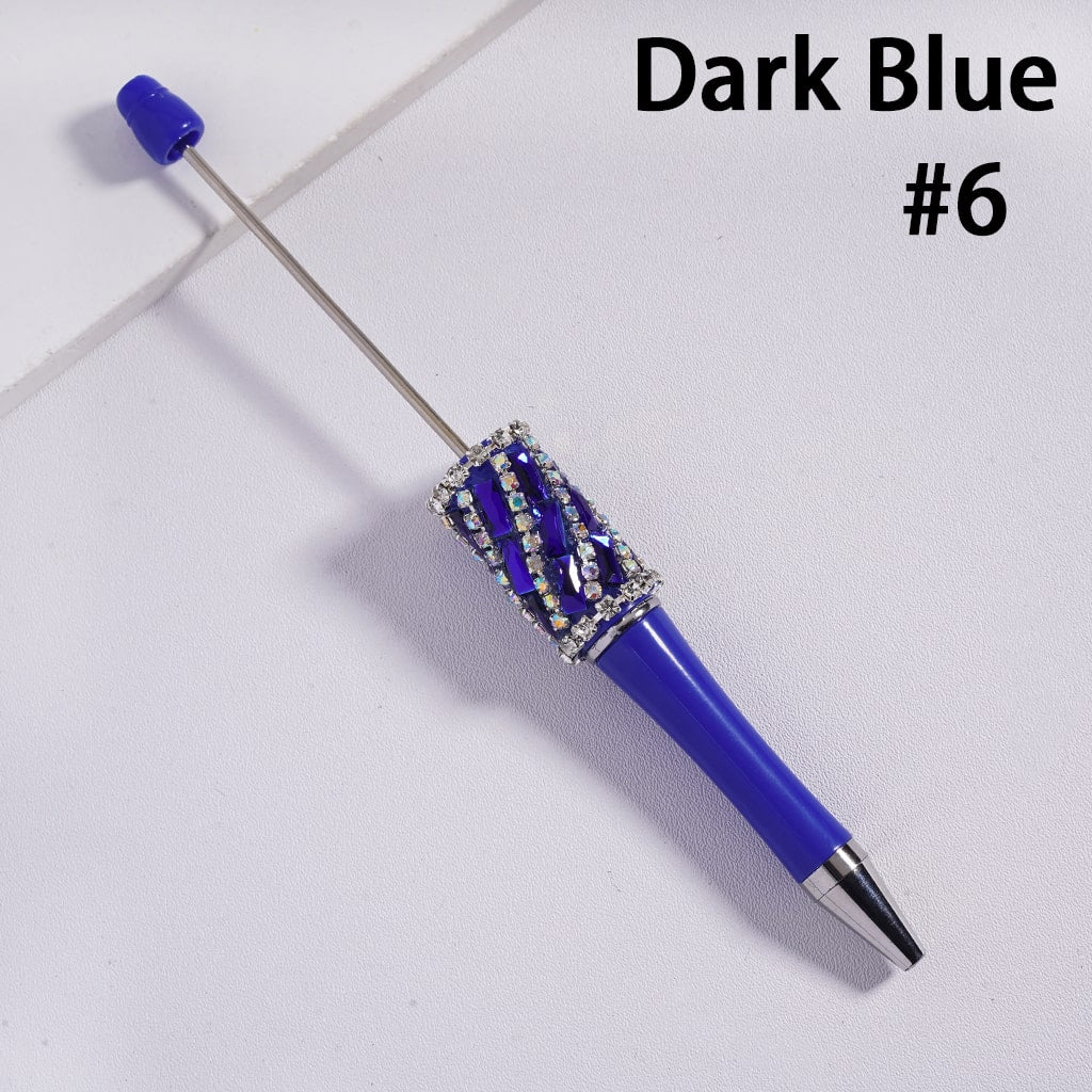 Dark blue pen with decorative elements on a light gray background