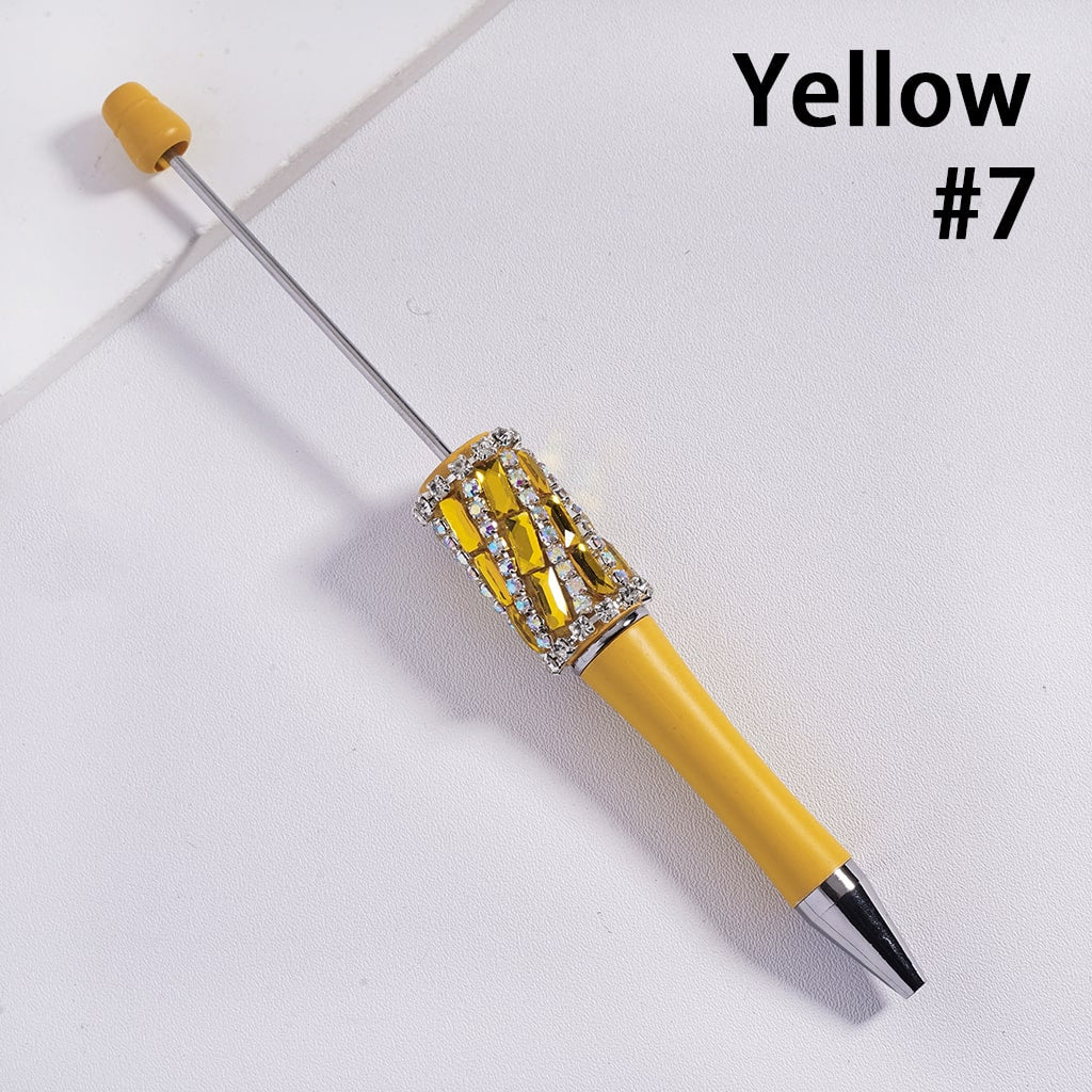 Yellow pen with decorative cap on a white background