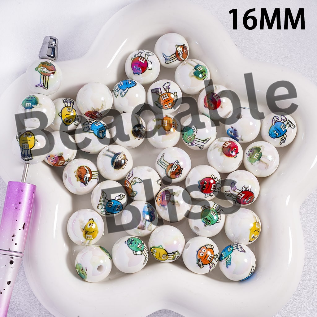 White beads with colorful cartoon characters on a white dish, with a purple pen on the side.