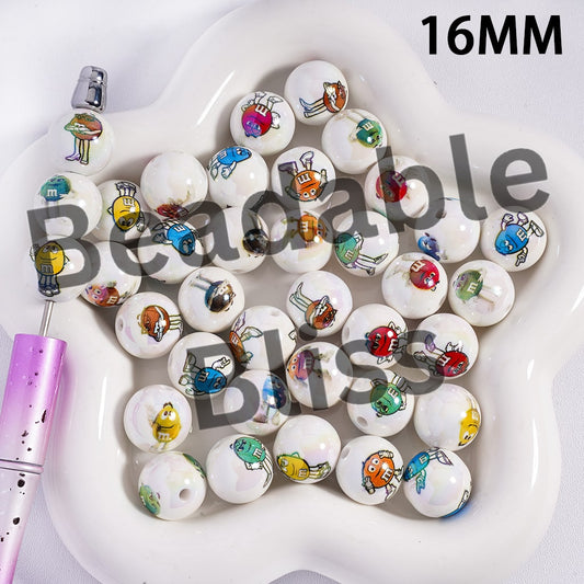 White beads with colorful cartoon characters on a white dish, with a purple pen on the side.