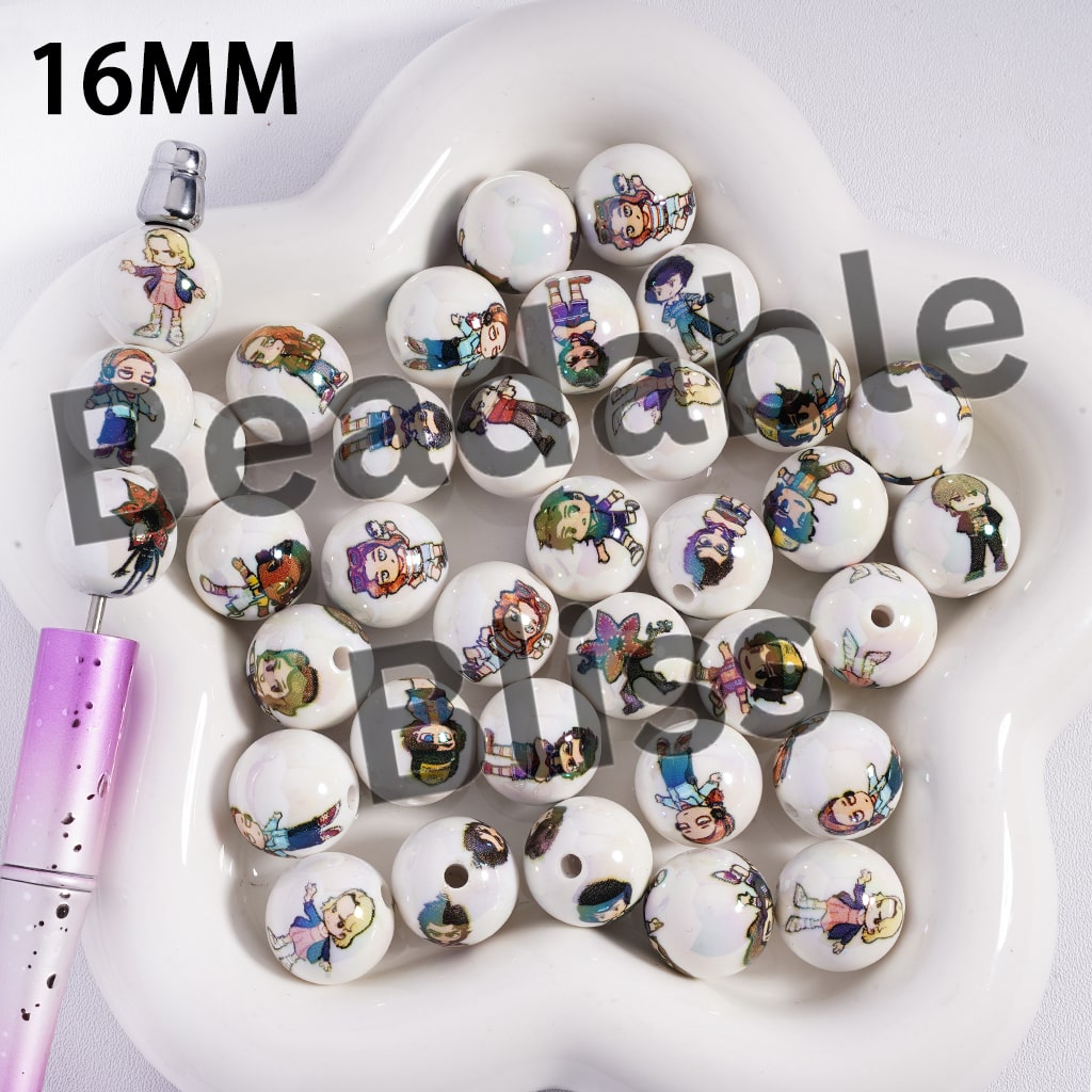 Set of white beads with colorful character illustrations on a heart-shaped white dish.