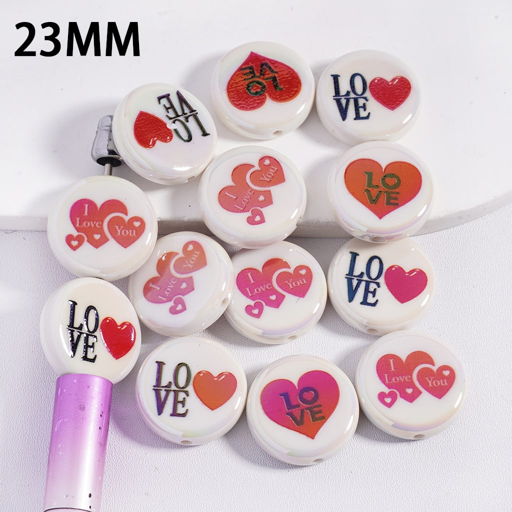 Set of 23mm buttons with heart and text designs on a white background