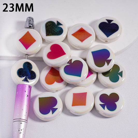 Set of colorful card suit symbols on white buttons with a marker on a white background.