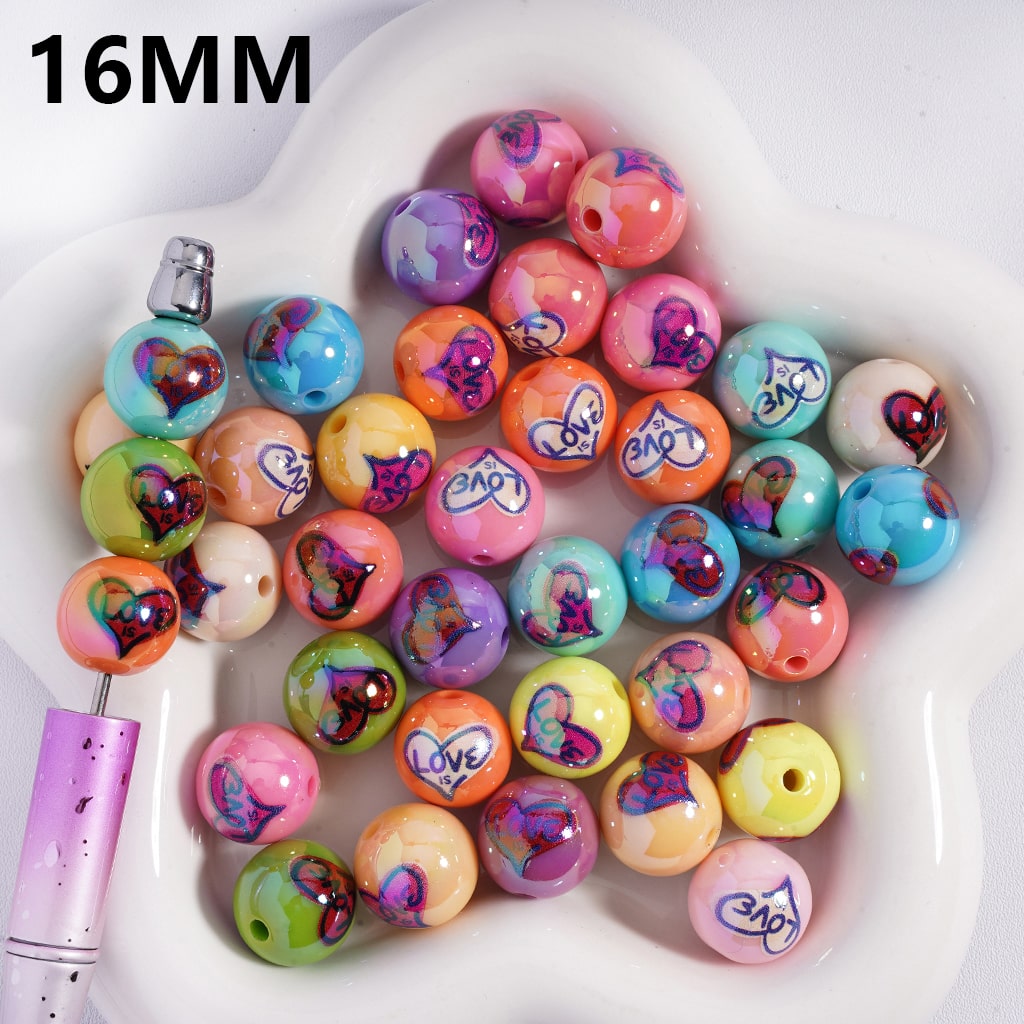 Assorted colorful beads with heart designs and 'love' text on a white dish, with a 16MM label.