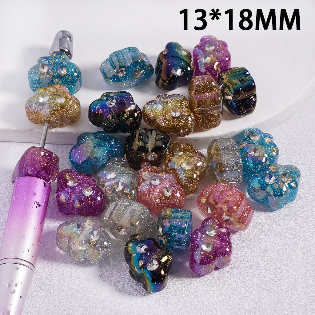 Multicolored beads with a tool on a white background, labeled 13*18MM.